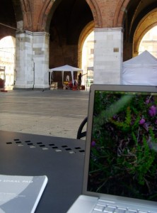 view of a laptop and italian town square