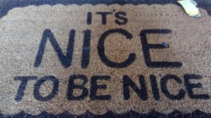 it's nice to be nice printed on a doormat