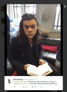 harry styles reading a book looking a bit sad