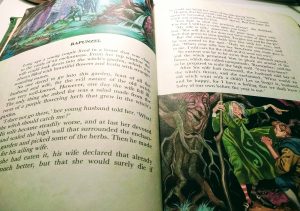 page from a fairy tale book illustrating rapunzel including a picture of a witch and tangled trees