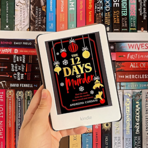 image of a kindle with the twelve days of murder cover on it against a backdrop of a bookshelf full of thrillers