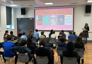 me delivering a talk on my love of books to a group of autistic students.